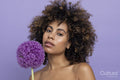 Portrait of brunette holding purple flower