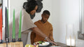 Mother and son setting table for Kwanzaa meal