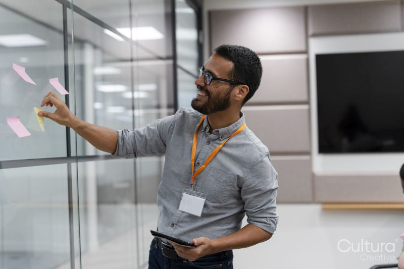 Man using adhesive notes in office