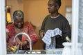 Senior couple washing dishes at home