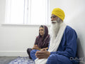 Senior couple in traditional clothing praying at home