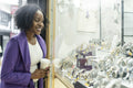 Woman looking through store window on wristwatch display