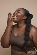Studio shot of smiling young woman with braided hair