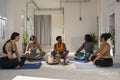 Smiling women sitting in yoga studio