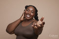 Studio portrait of smiling young woman with braided hair