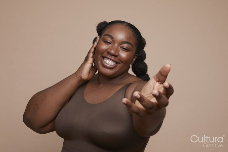 Studio portrait of smiling young woman with braided hair