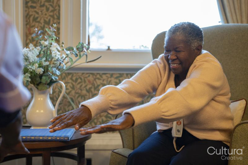 Smiling senior woman exercising in nursing home