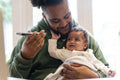 Father holding baby daughter and smart phone