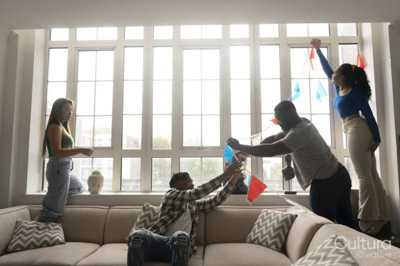 Friends decorating window with pennant flags