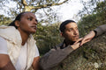 Portrait of couple leaning on tree branch