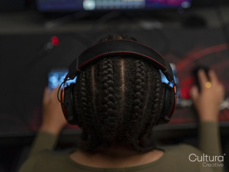 Rear view of female gamer playing on computer