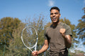 Smiling man with tennis racket
