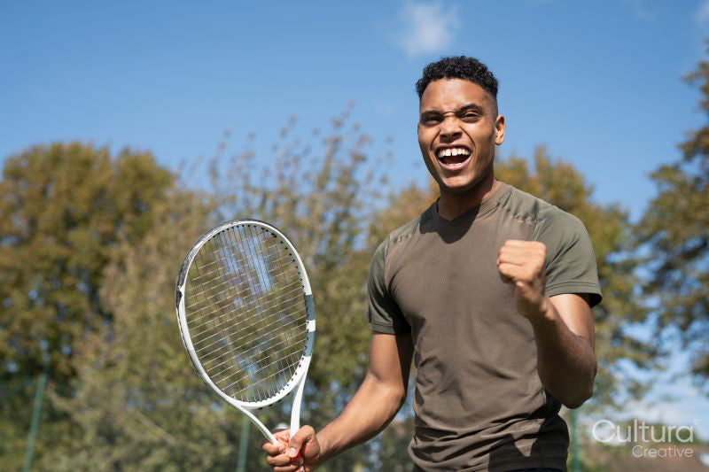 Smiling man with tennis racket