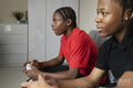 Teenage friends playing video game at home