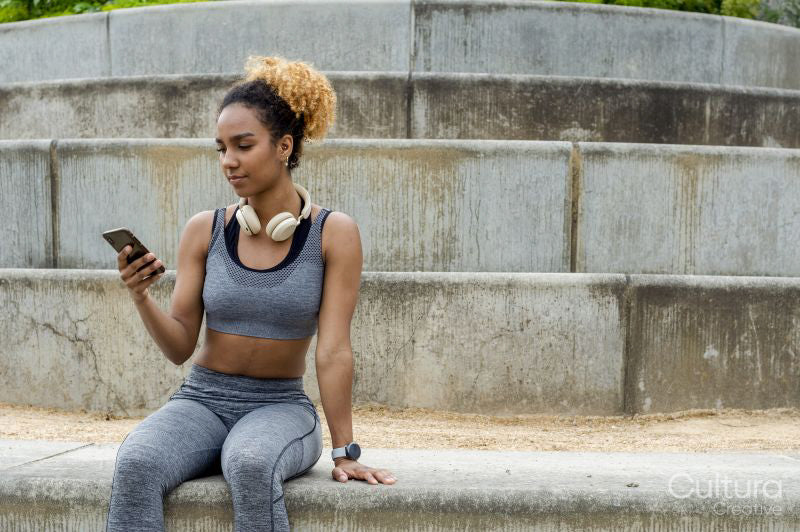 Sporty young woman using phone