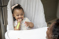 Baby girl sitting in high chair
