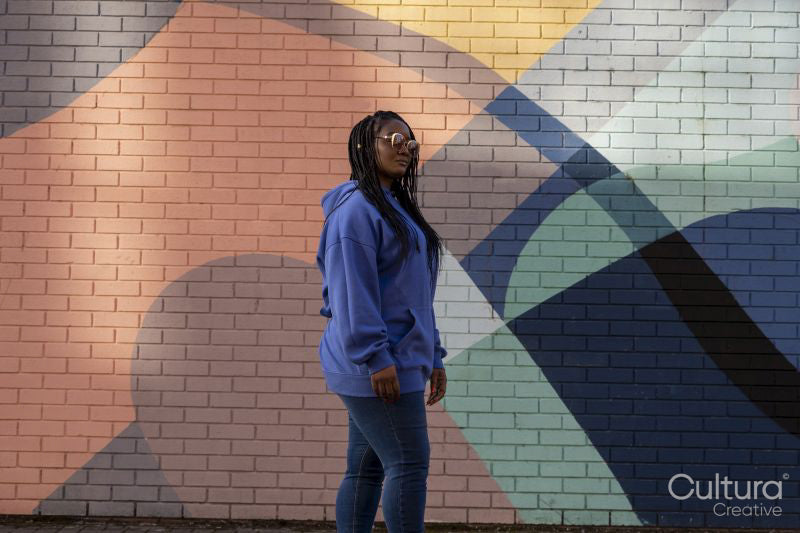 South Yorkshire, Woman with braided hair against colorful wall
