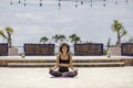 Woman meditating on terrace