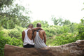 Louisiana, Rear view of couple sitting on log in forest