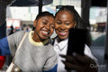 Young female friends taking selfie on merry-go-round