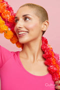 Smiling young blond woman wearing floral garland