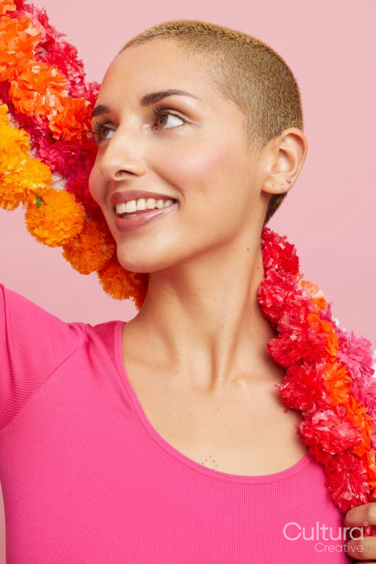 Smiling young blond woman wearing floral garland