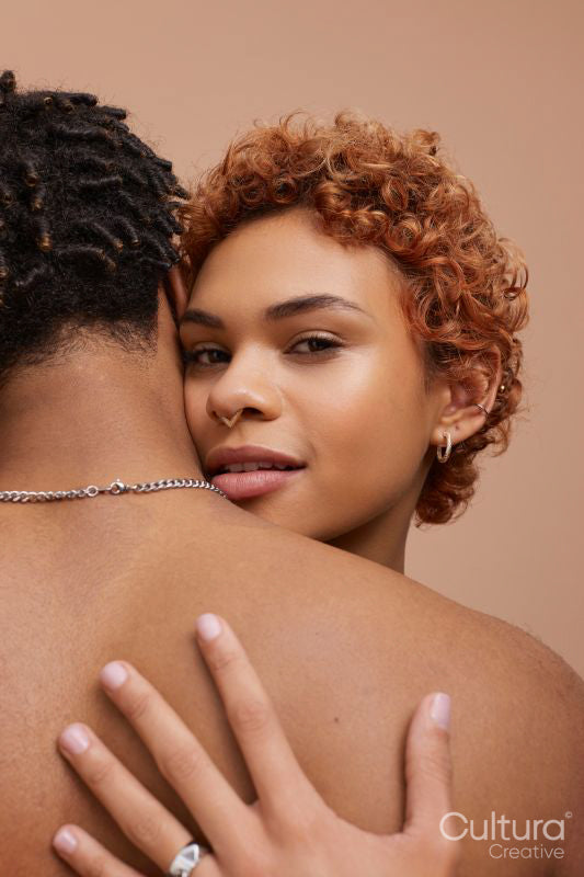 Studio portrait of happy young couple hugging
