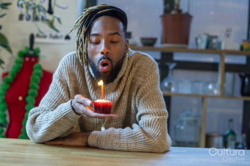 Man blowing at candle