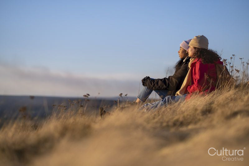 Female friends looking at landscape at sunset