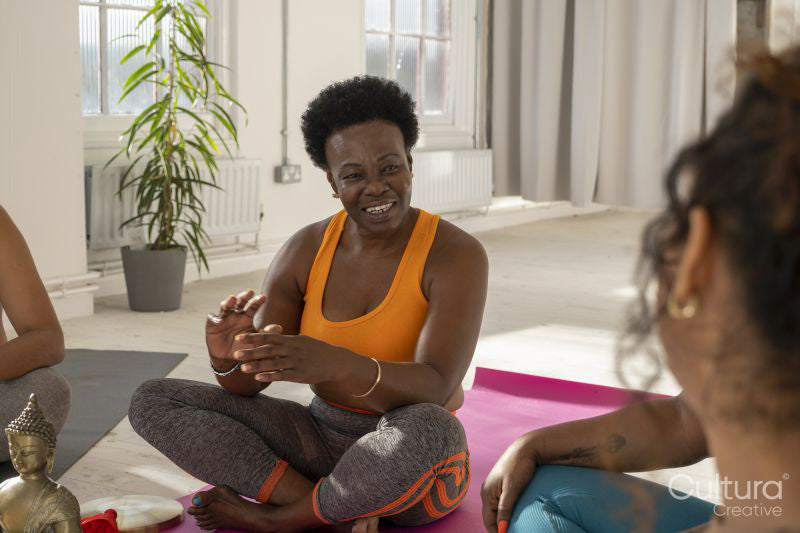 Smiling women talking in yoga studio