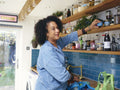Woman unpacking grocery bags in kitchen