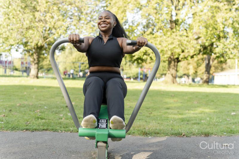 Young woman exercising in outdoor gym