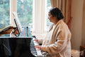 Senior woman playing piano