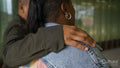 Rear view of two women embracing
