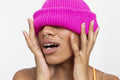 Studio portrait of woman in pink woolen cap