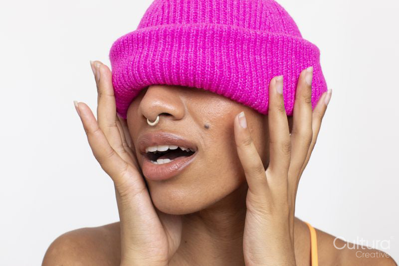 Studio portrait of woman in pink woolen cap