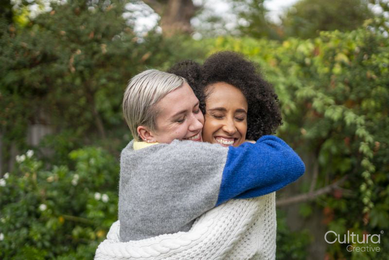 Smiling couple embracing in garden