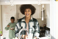 Mother and son washing dishes and cooking in kitchen