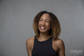 Portrait of smiling woman with curly hair