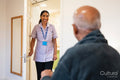Nurse visiting senior man in his room at nursing home
