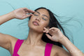 Woman with tousled hair and closed eyes