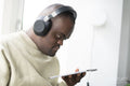 Man with Down syndrome using tablet and wearing headphones