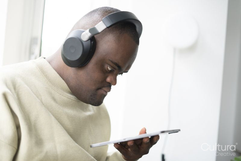 Man with Down syndrome using tablet and wearing headphones