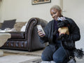 Woman taking selfie with Shih Tzu Poodle at home