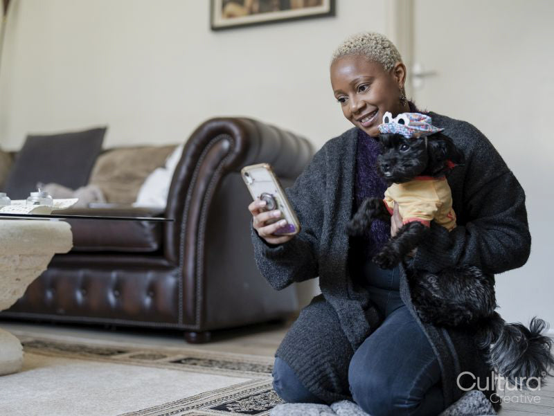 Woman taking selfie with Shih Tzu Poodle at home