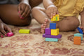 Mother playing with baby daughter at home