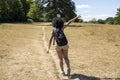 Young woman hiking in countryside, rear view