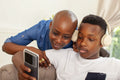Mother and son using headphones and smart phone