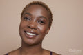 Studio portrait of smiling woman with nose ring