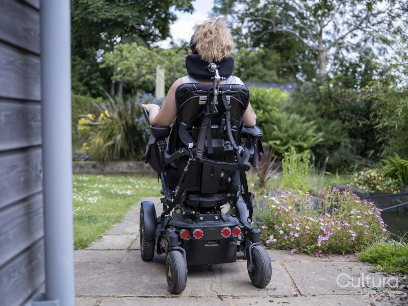 Woman in electric wheelchair outdoors